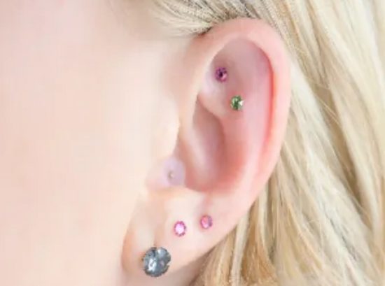 Coloured Ear Seeds on a woman's ear