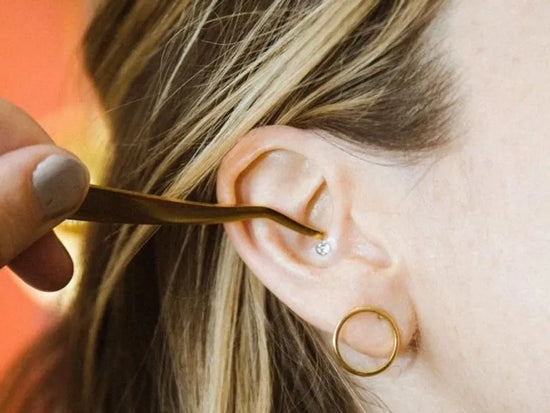 Woman's ear having ear seeds applied